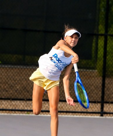 High Performance junior reaching up into a serve at RacFit in Buda, Texas