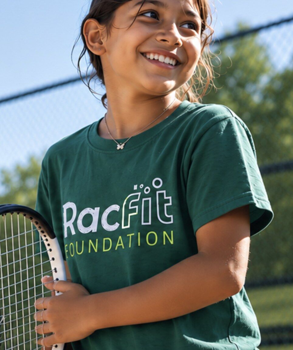 Young player holding a racquet after a junior tennis lesson at RacFit in Buda, Texas