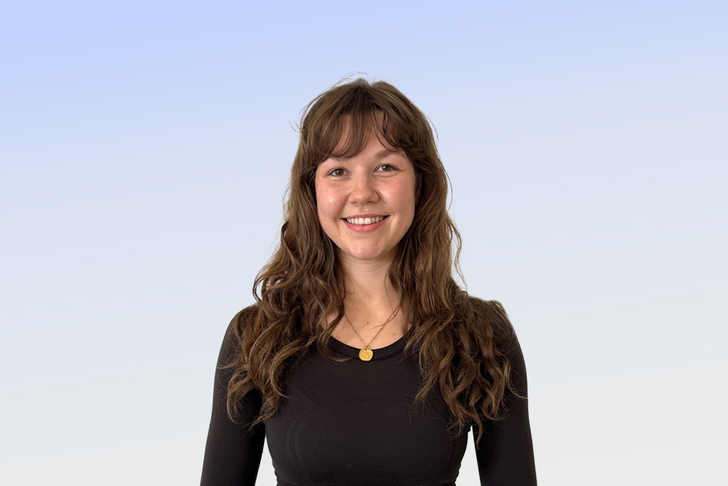 Smiling person with long hair, blue gradient background.