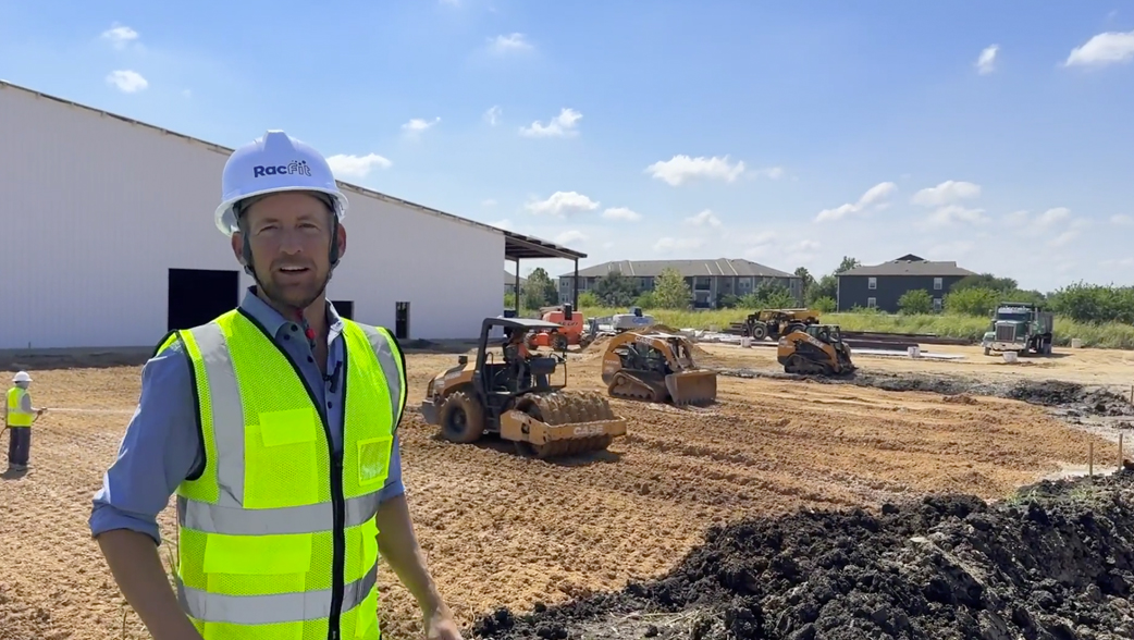 Construction site with workers and heavy machinery.
