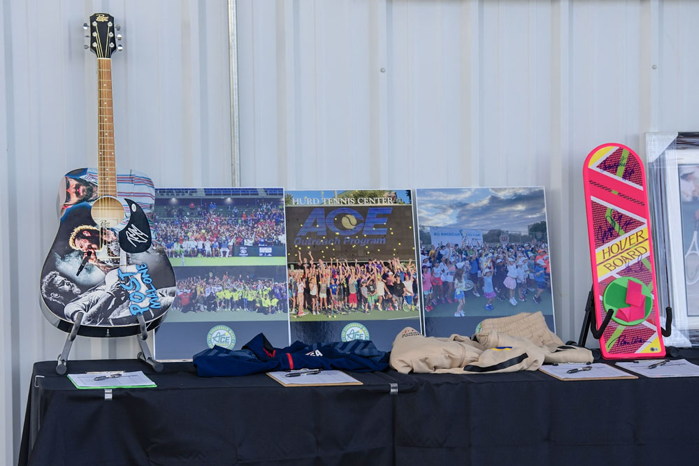 Display table with guitar, posters, and hoverboard